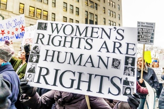 women protesting banner